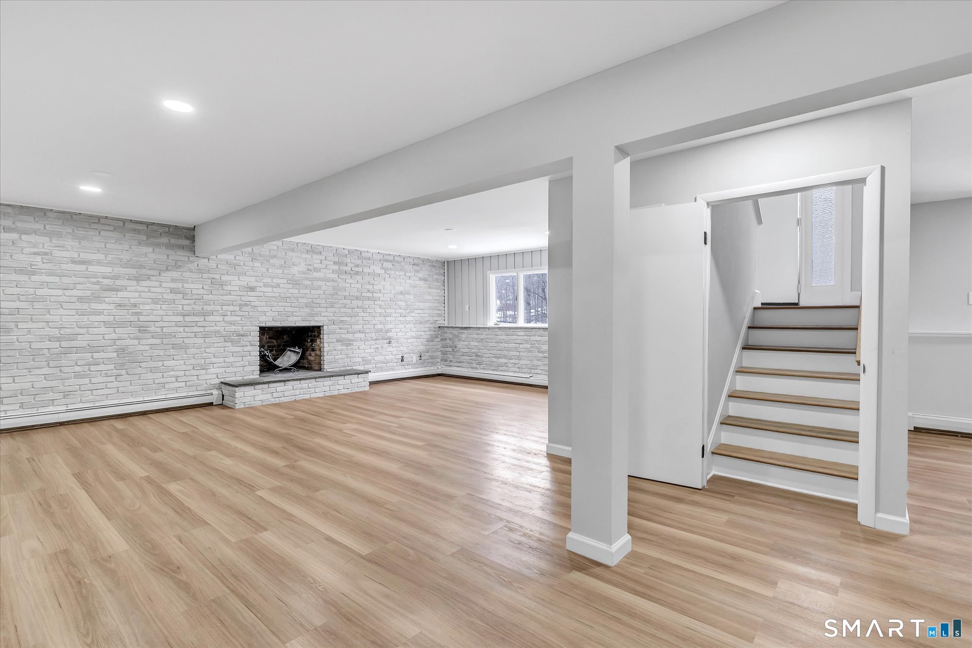 176 Strobel Road Trumbull, CT 06611 - Photo 33 of 39 a view of empty room with wooden floor and fireplace