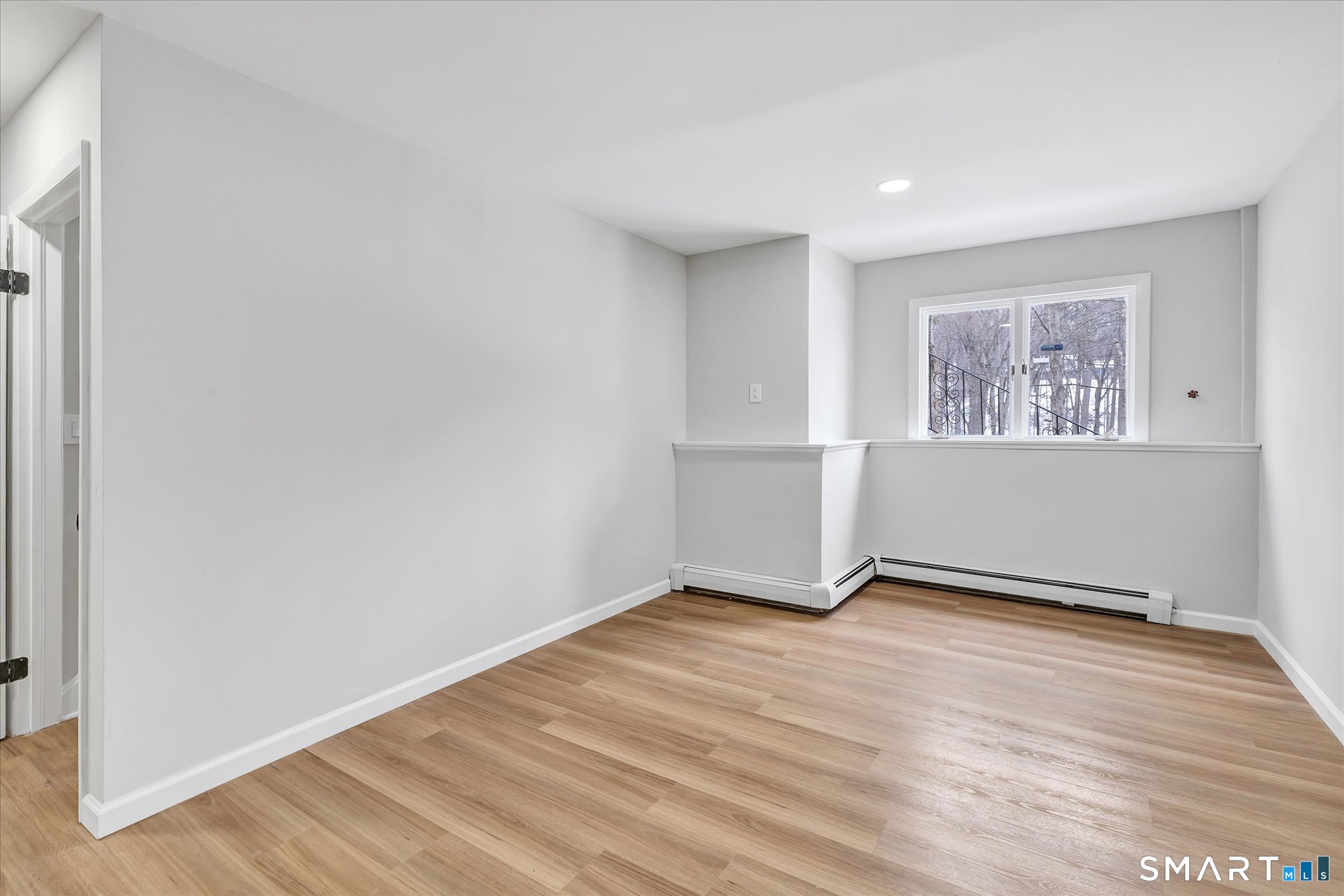 176 Strobel Road Trumbull, CT 06611 - Photo 35 of 39 an empty room with wooden floor and windows