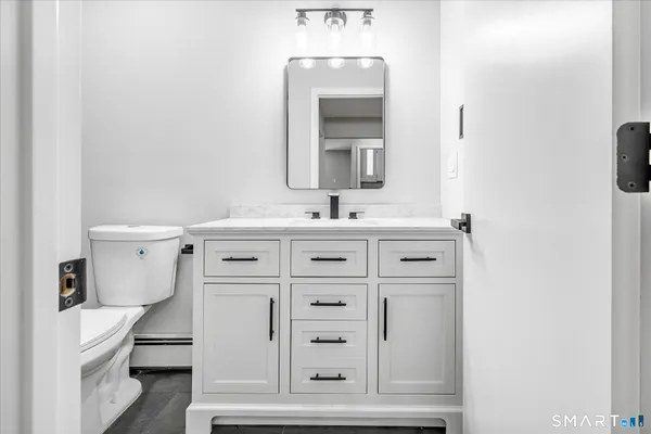 a bathroom with a sink vanity and mirror