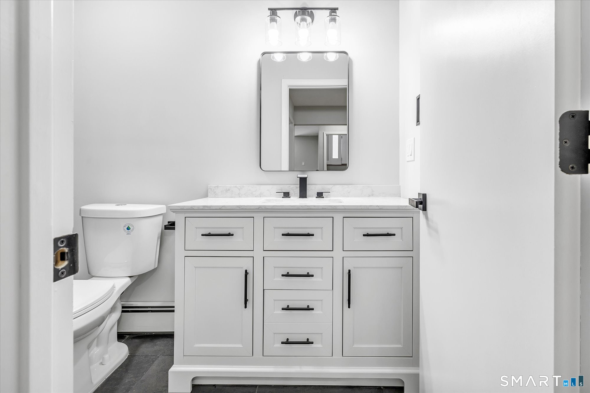 176 Strobel Road Trumbull, CT 06611 - Photo 37 of 39 a bathroom with a sink vanity and mirror