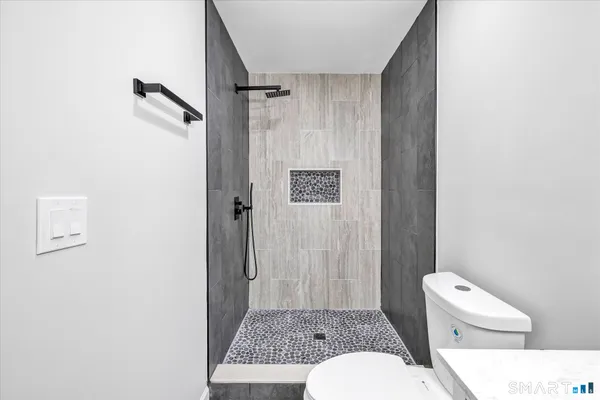 a bathroom with a toilet a sink and shower