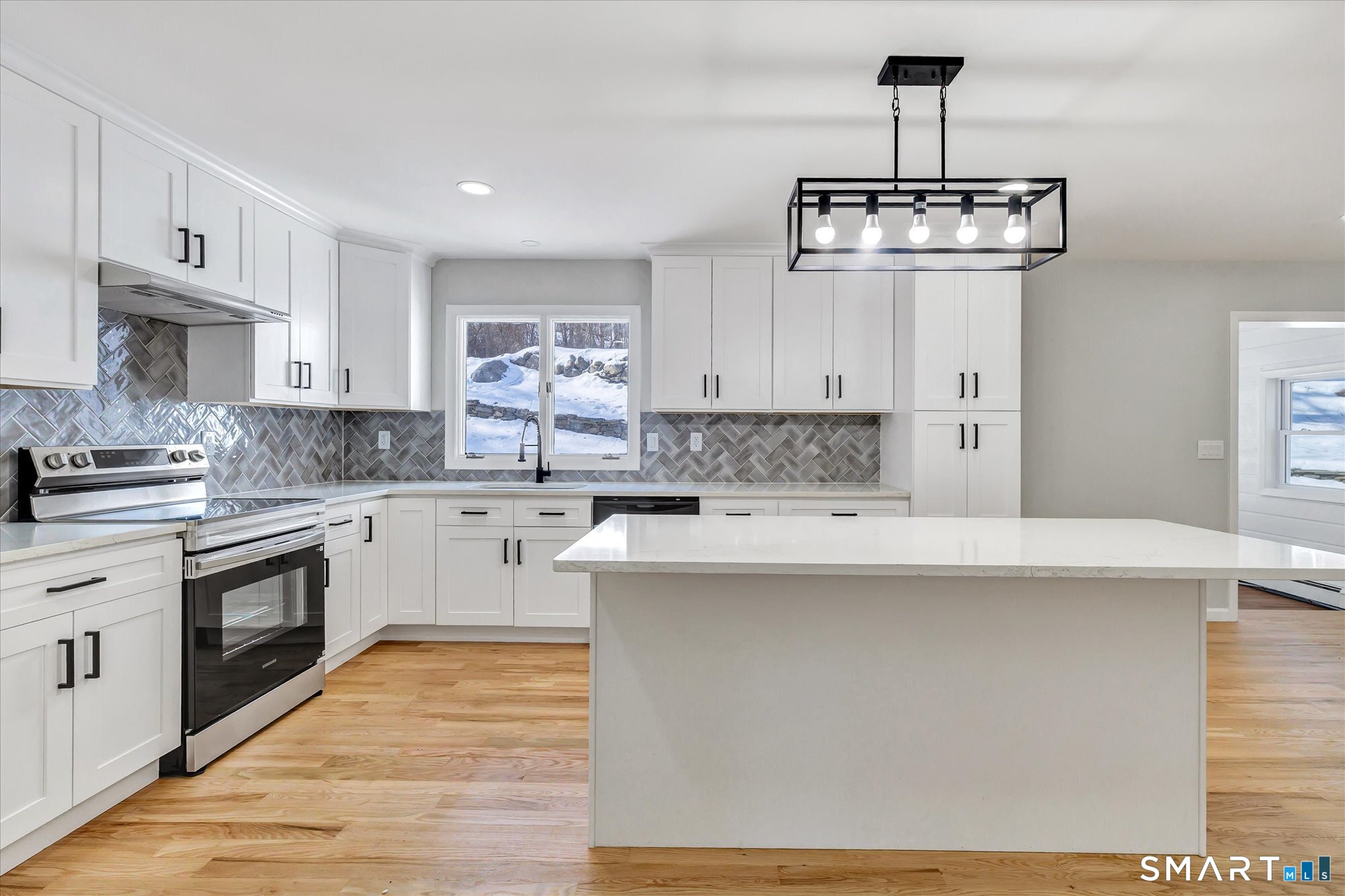 176 Strobel Road Trumbull, CT 06611 - Photo 5 of 39 a kitchen with stainless steel appliances a stove a sink dishwasher a refrigerator and white cabinets with wooden floor