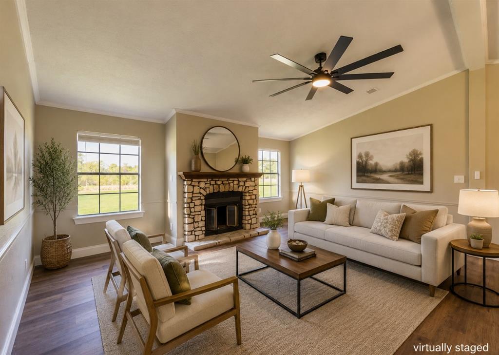 109 Brookshire Street Riesel, TX 76682 - Photo 4 of 18 Living area featuring a stone-clad fireplace with a wood mantel, wood-finish flooring, and a multi-blade ceiling fan