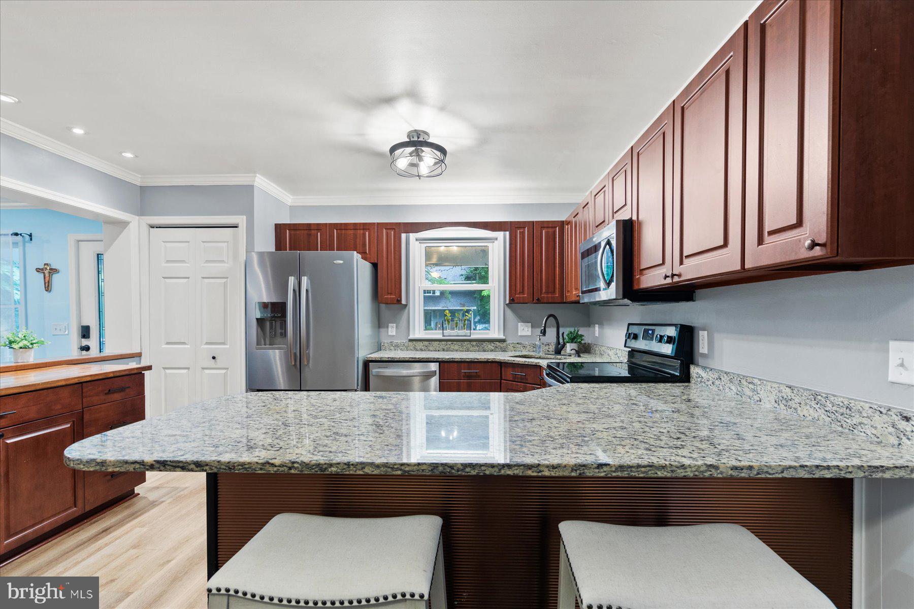 4 Poacher Berlin, MD 21811 - Photo 12 of 45 a kitchen with stainless steel appliances kitchen island granite countertop a table chairs in it and wooden floors