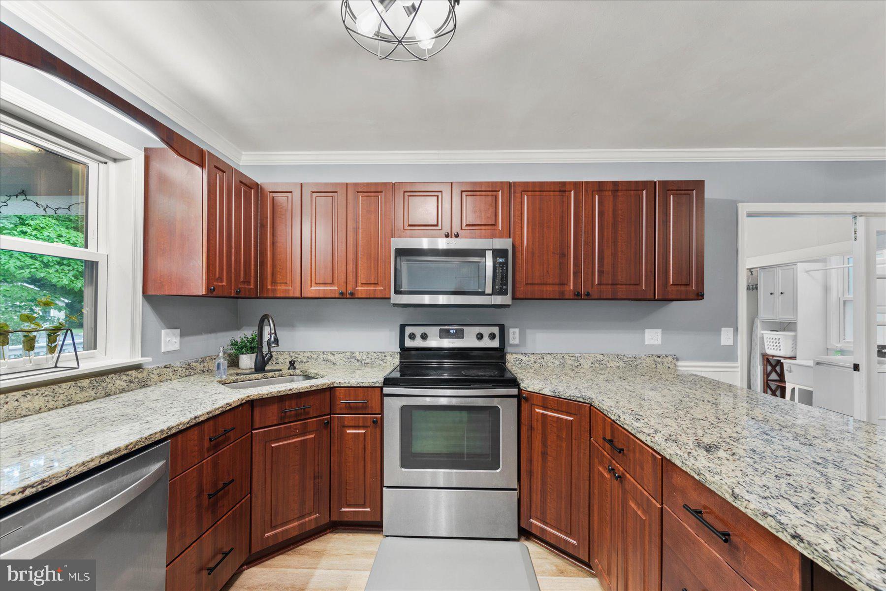 4 Poacher Berlin, MD 21811 - Photo 15 of 45 a kitchen with granite countertop a sink a stove and cabinets