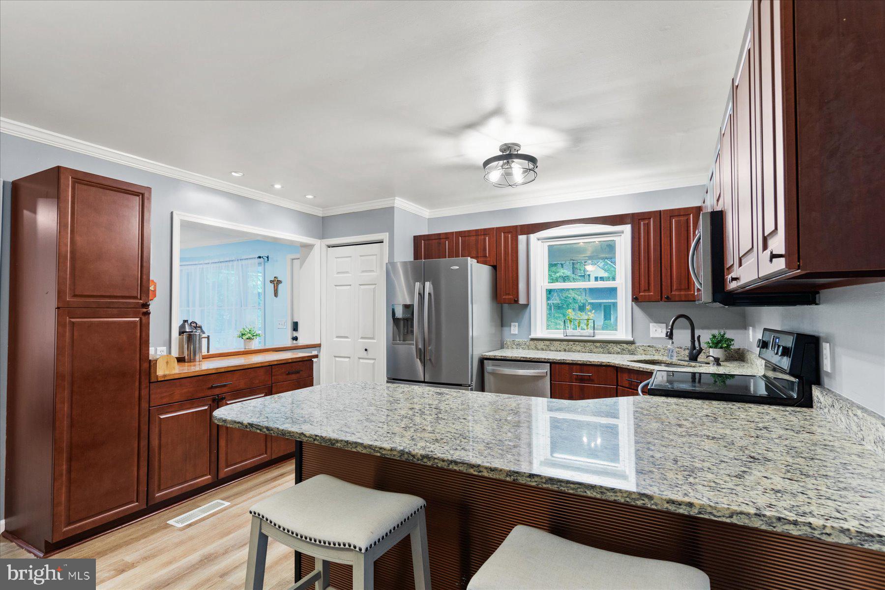 4 Poacher Berlin, MD 21811 - Photo 19 of 45 a kitchen with stainless steel appliances granite countertop a sink refrigerator and cabinets