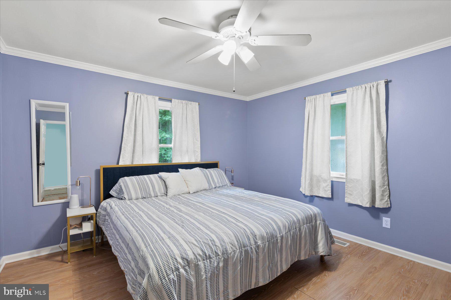 4 Poacher Berlin, MD 21811 - Photo 20 of 45 a bedroom with a large bed and a chandelier