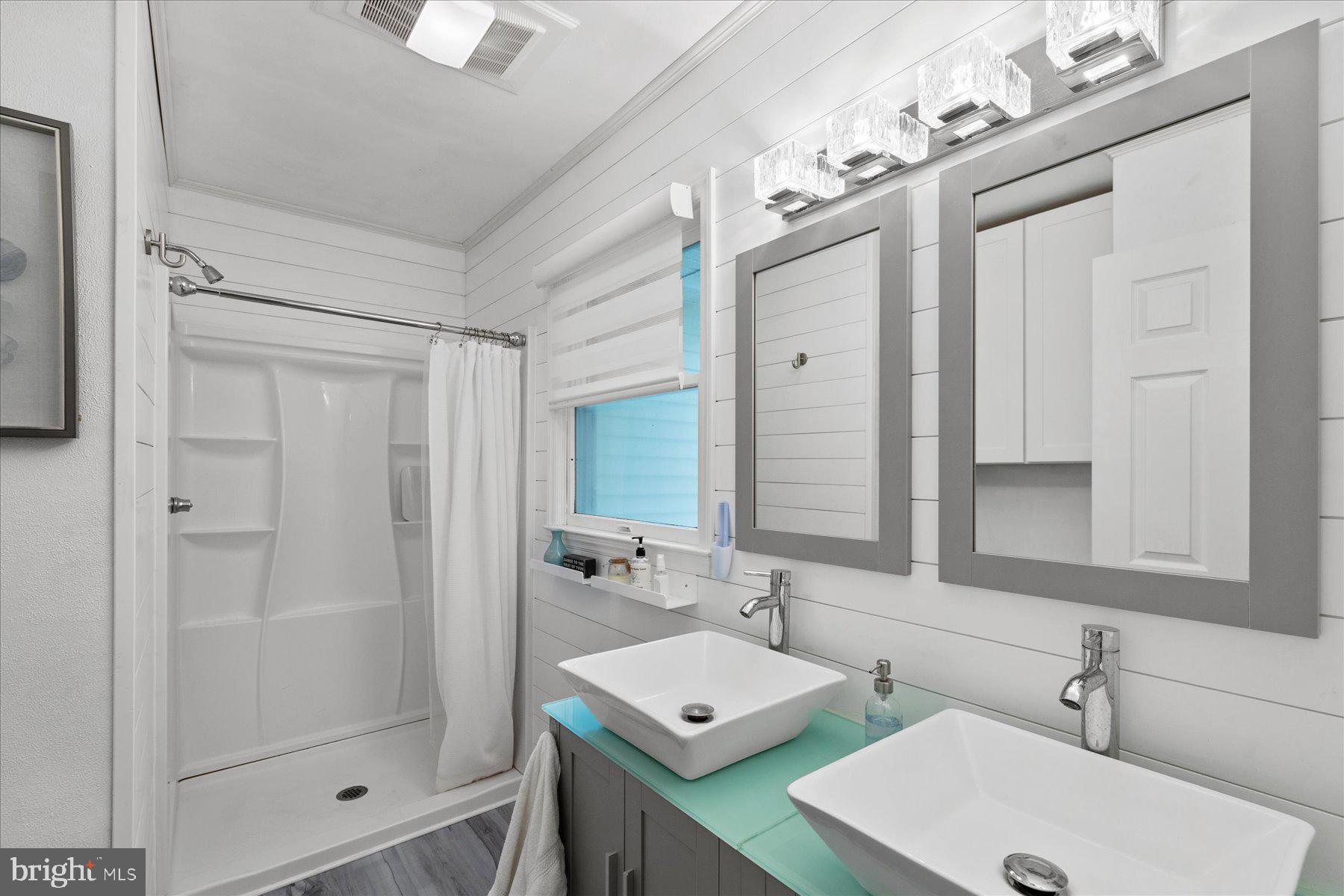 4 Poacher Berlin, MD 21811 - Photo 24 of 45 a bathroom with a double vanity sink mirror and shower