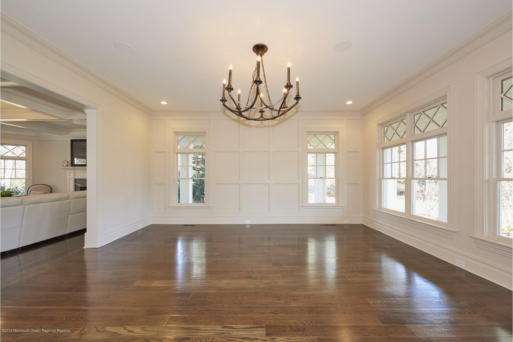 8 Heathcliff Road Rumson, NJ 07760 - Photo 17 of 46 a view of an empty room with wooden floor and a window