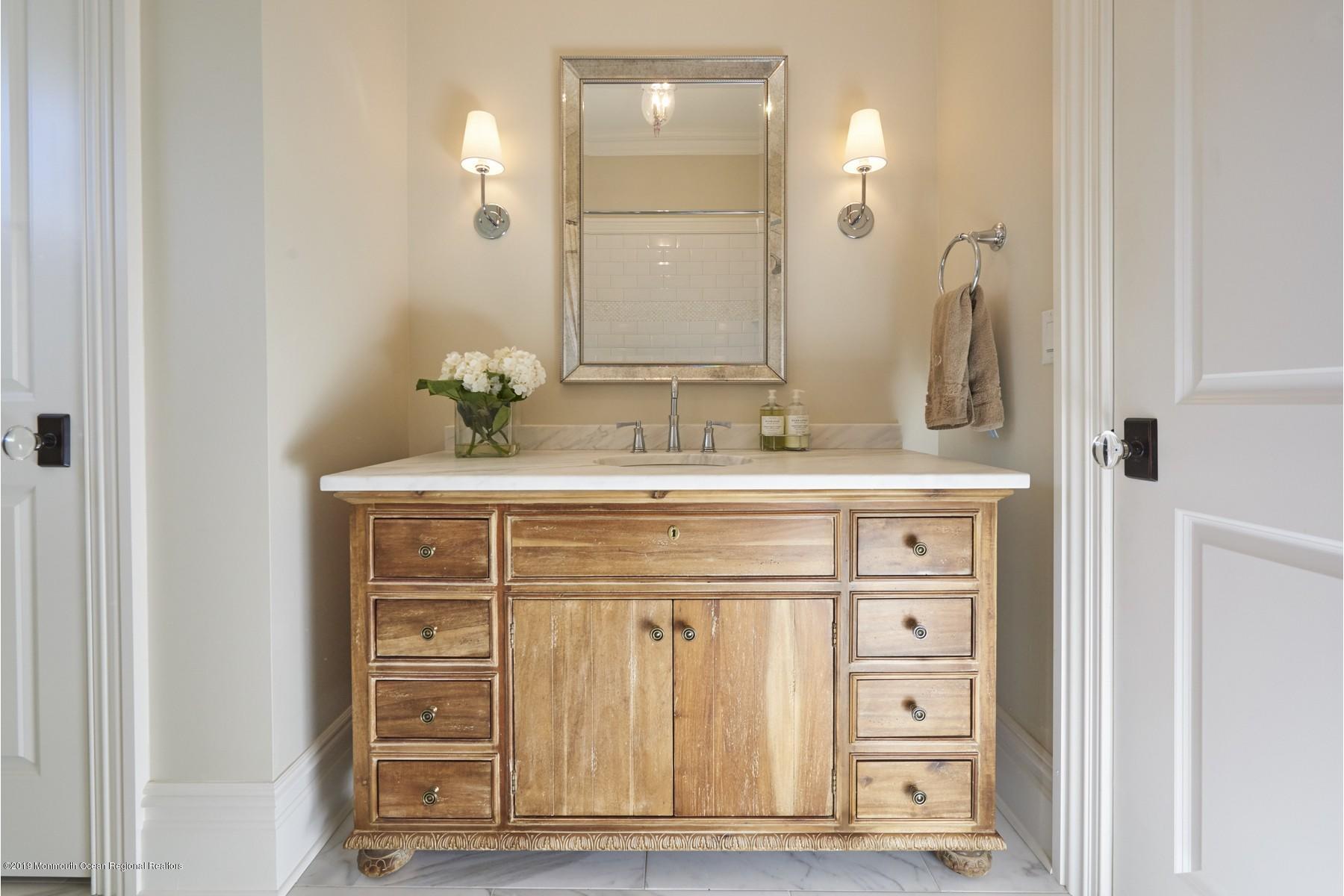 8 Heathcliff Road Rumson, NJ 07760 - Photo 19 of 46 a bathroom with a sink vanity and a mirror