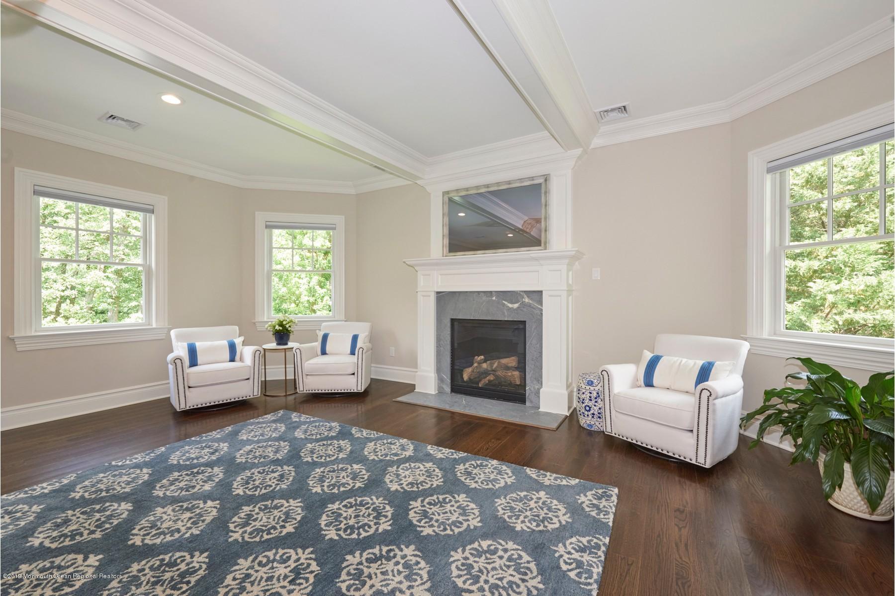 8 Heathcliff Road Rumson, NJ 07760 - Photo 23 of 46 a living room with furniture and a fireplace