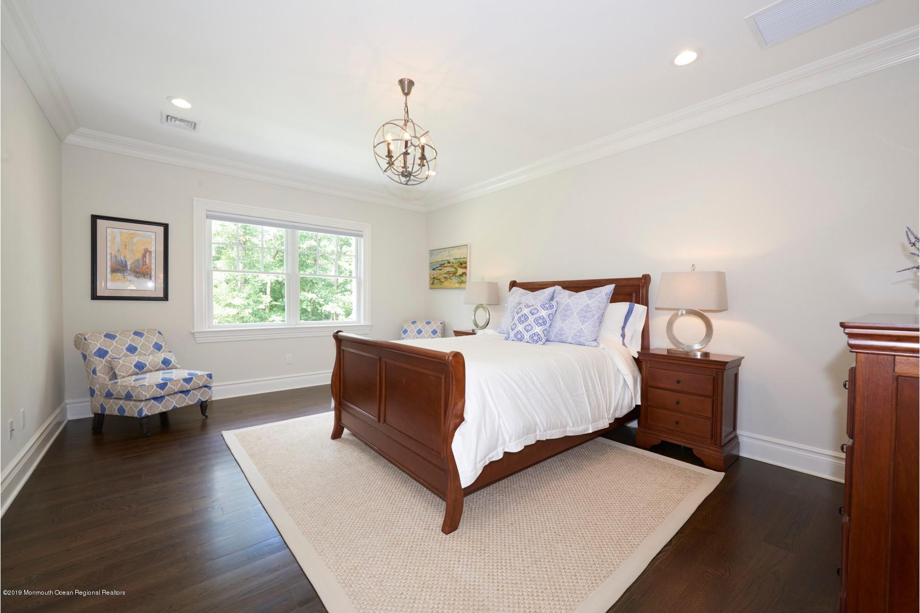 8 Heathcliff Road Rumson, NJ 07760 - Photo 26 of 46 a spacious bedroom with a bed and wooden floor