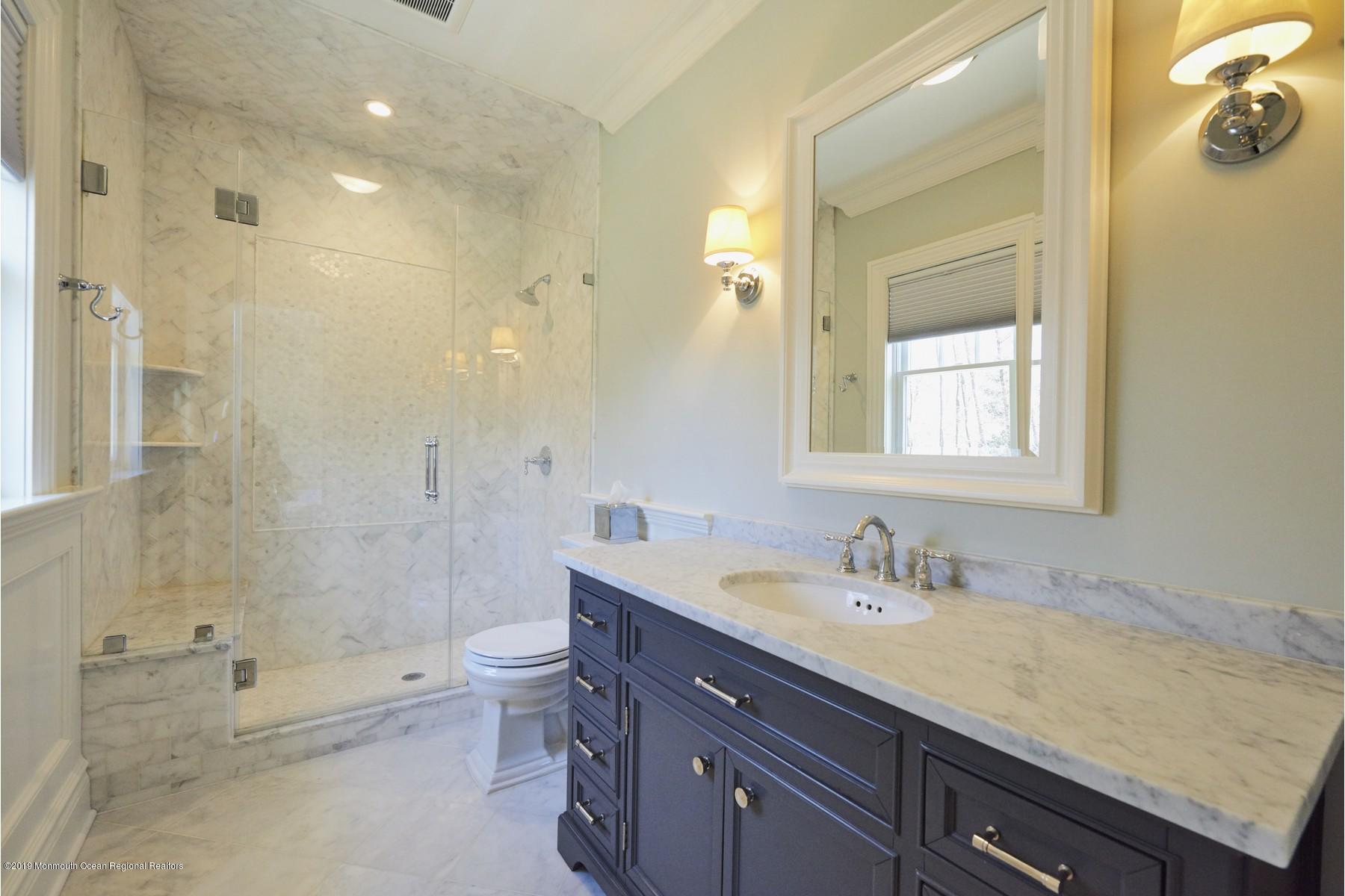 8 Heathcliff Road Rumson, NJ 07760 - Photo 27 of 46 a bathroom with a granite countertop sink a toilet a shower and a mirror