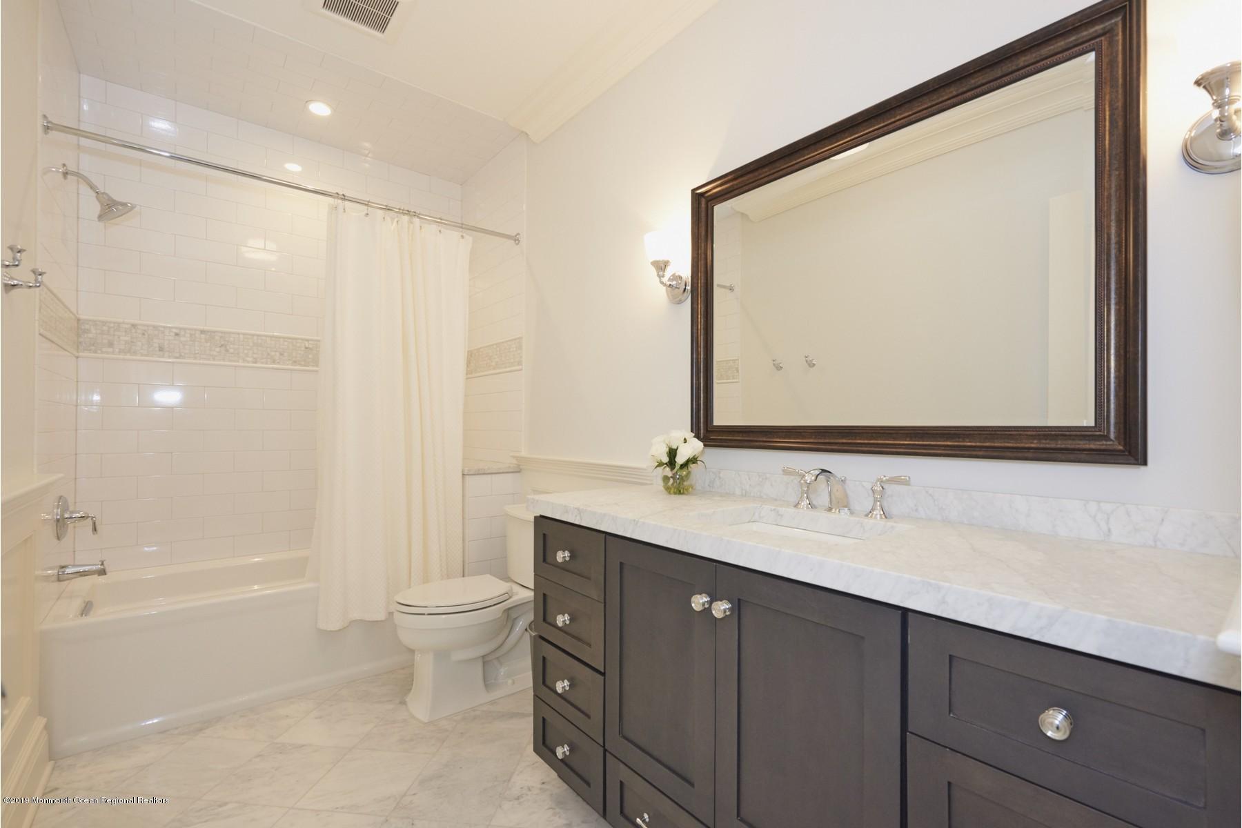 8 Heathcliff Road Rumson, NJ 07760 - Photo 30 of 46 a bathroom with a double vanity sink mirror double and a bathtub