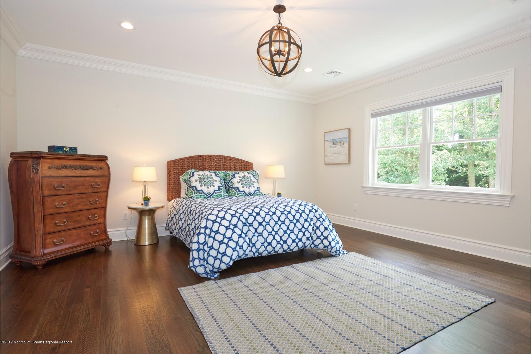 8 Heathcliff Road Rumson, NJ 07760 - Photo 31 of 46 a bedroom with a bed and wooden floor