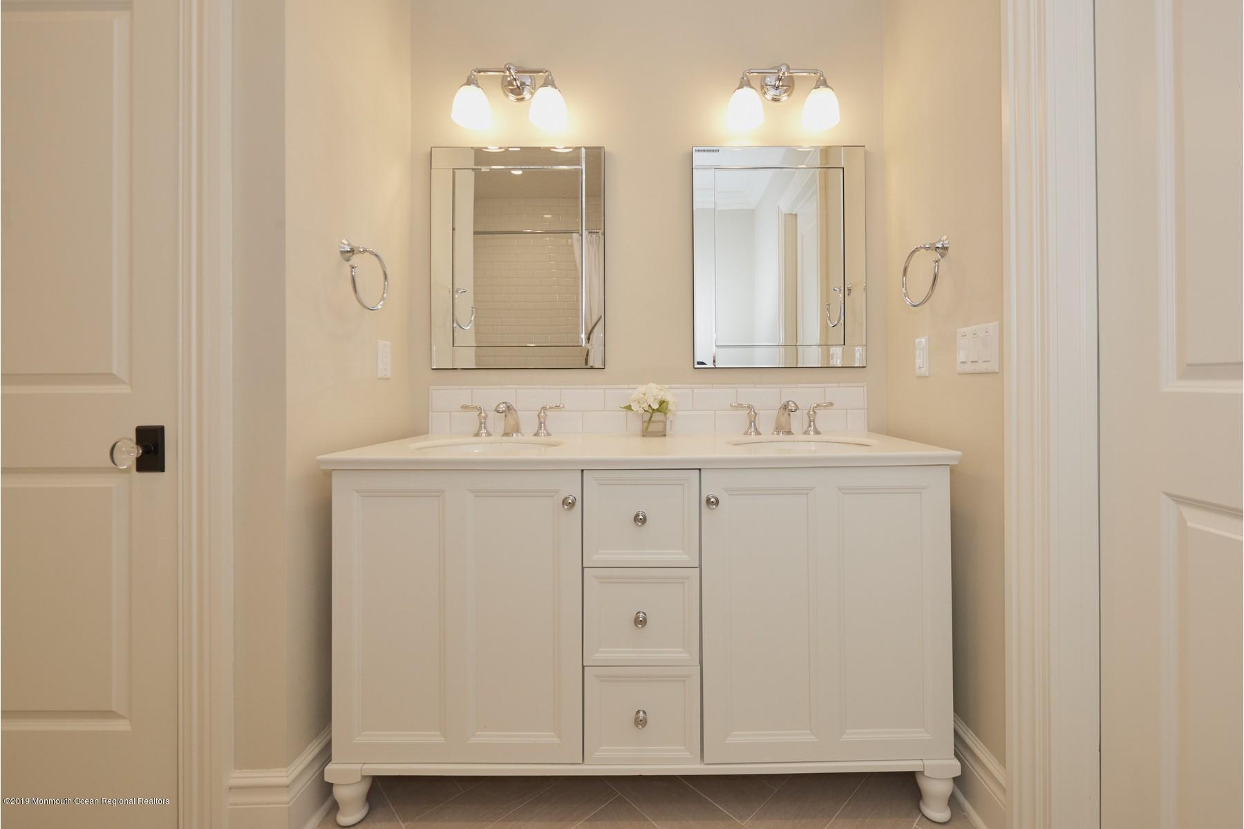 8 Heathcliff Road Rumson, NJ 07760 - Photo 32 of 46 a bathroom with double vanity sink and a mirror