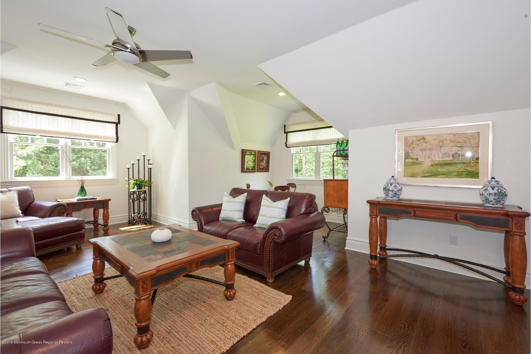 8 Heathcliff Road Rumson, NJ 07760 - Photo 34 of 46 a living room with furniture a table and wooden floor