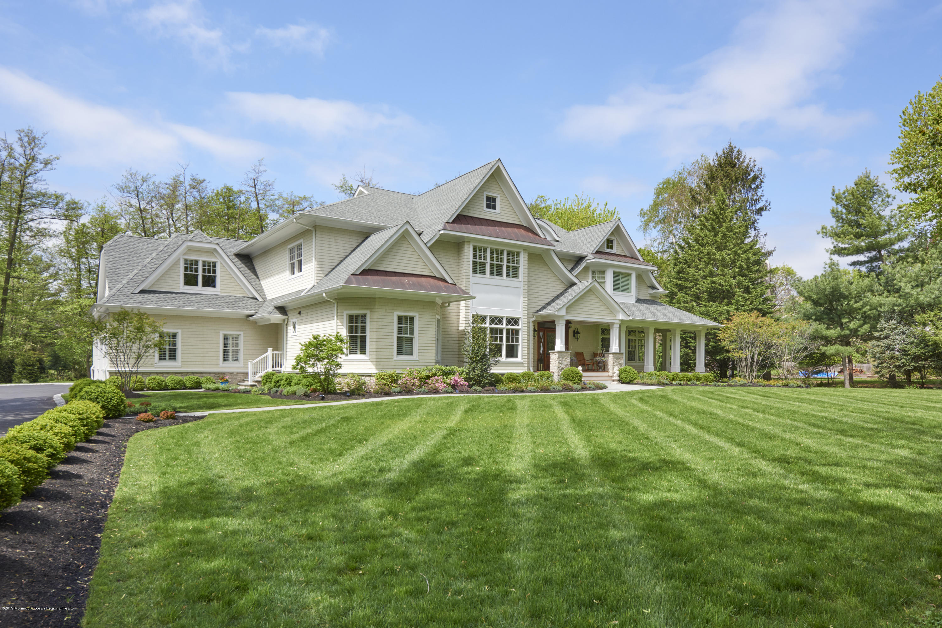 8 Heathcliff Road Rumson, NJ 07760 - Photo 45 of 46 a front view of a house with a yard table and chairs