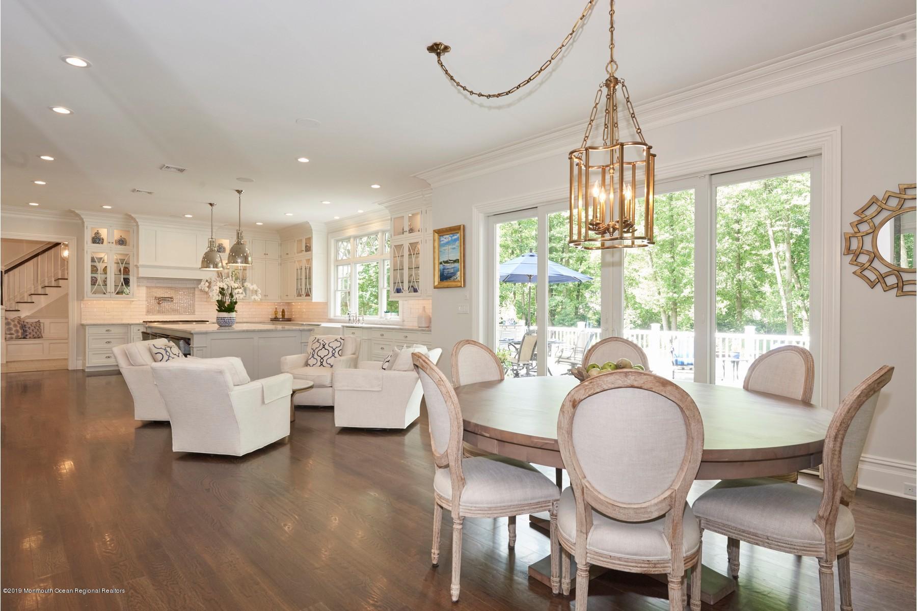 8 Heathcliff Road Rumson, NJ 07760 - Photo 8 of 46 a dining room with furniture a chandelier and wooden floor