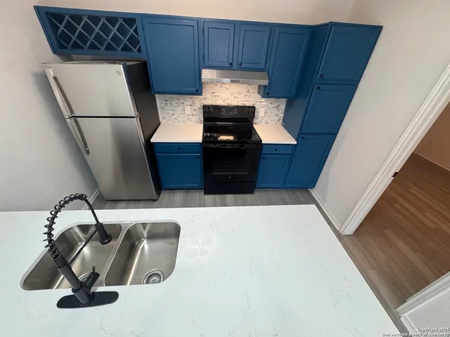 a kitchen with a cabinets and wooden floor