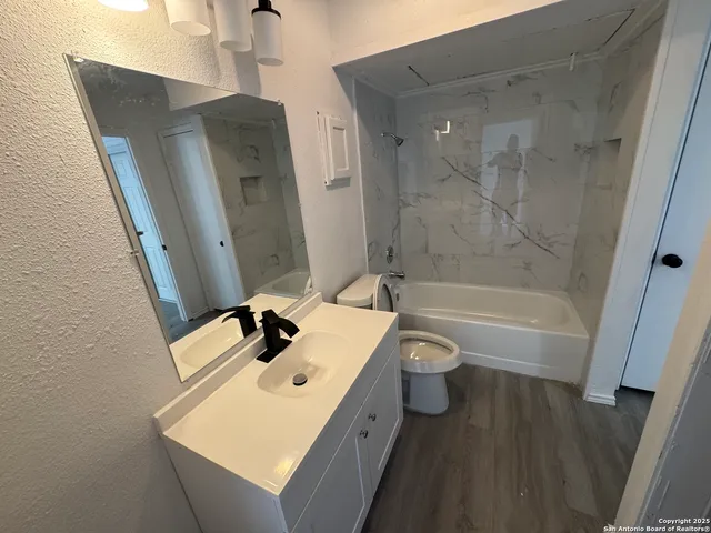 a bathroom with a toilet and a bath tub