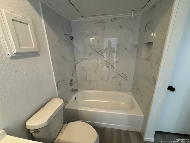 a bathroom with a bathtub and a shower