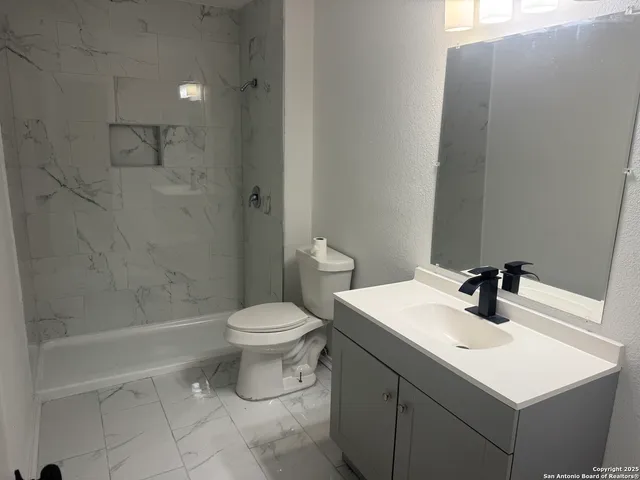 a bathroom with a bathtub and shower