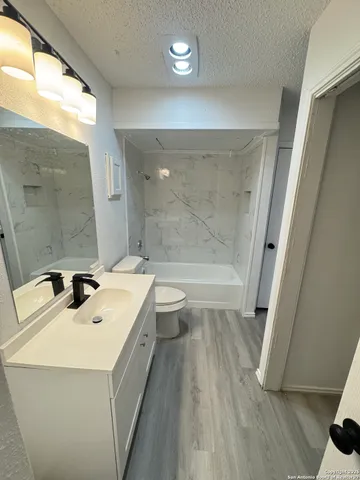 a bathroom with a sink toilet and a mirror