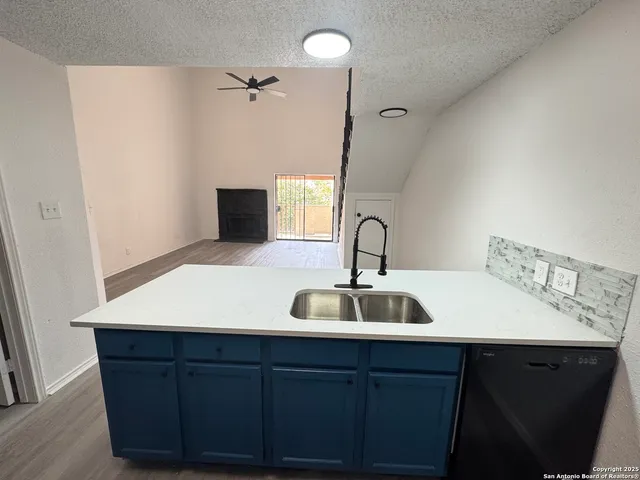 a kitchen with refrigerator and sink