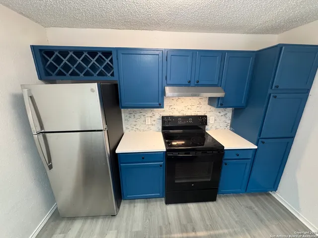 a kitchen with sink cabinets and wooden floor