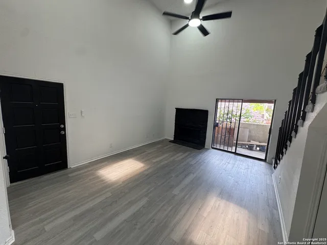 a view of a room with wooden floor and cabinet