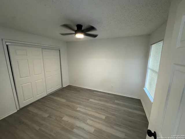 a bedroom with a bed and a mirror