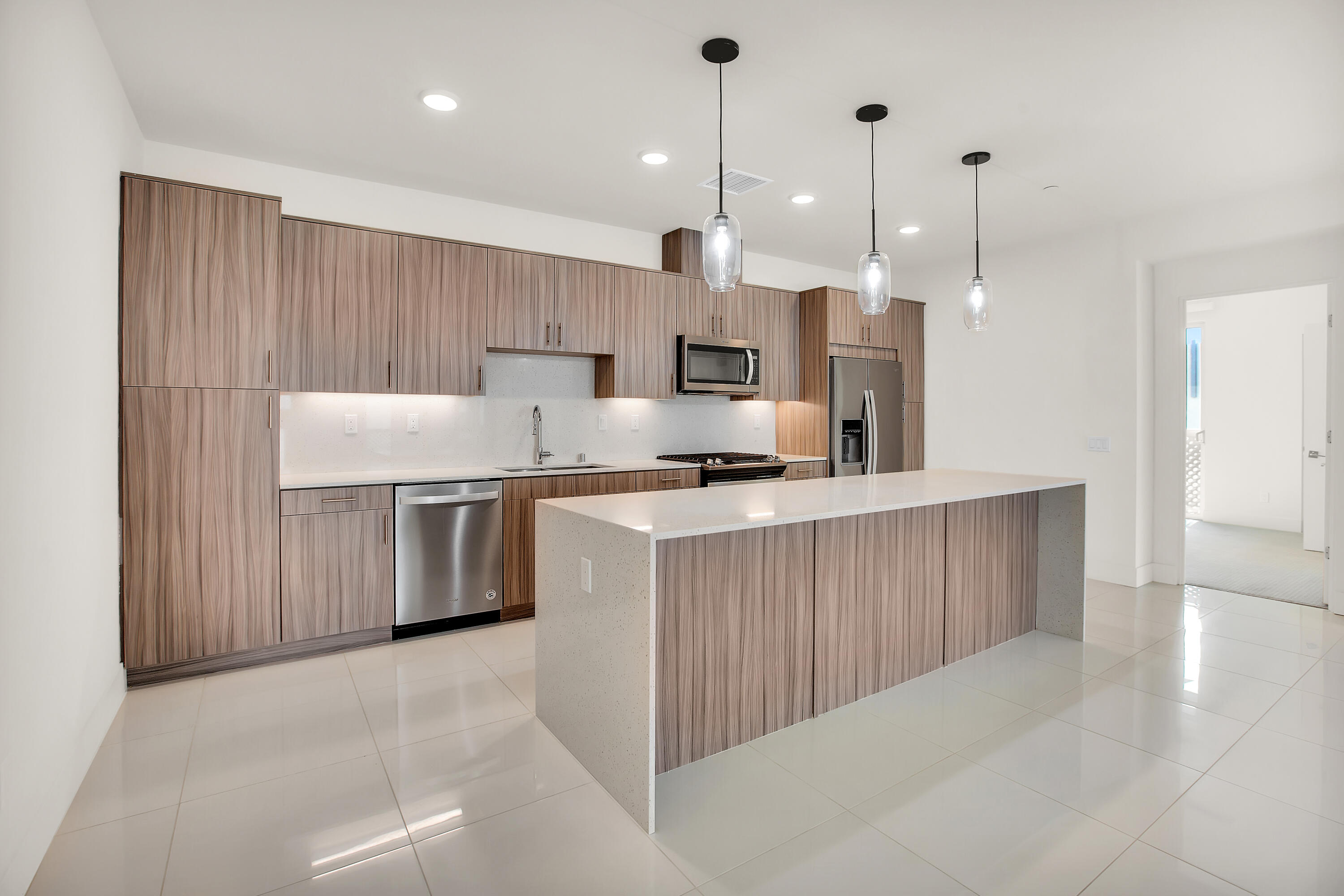 191 The Riv Palm Springs, CA 92262 - Photo 11 of 33 a kitchen with stainless steel appliances kitchen island a refrigerator sink and cabinets