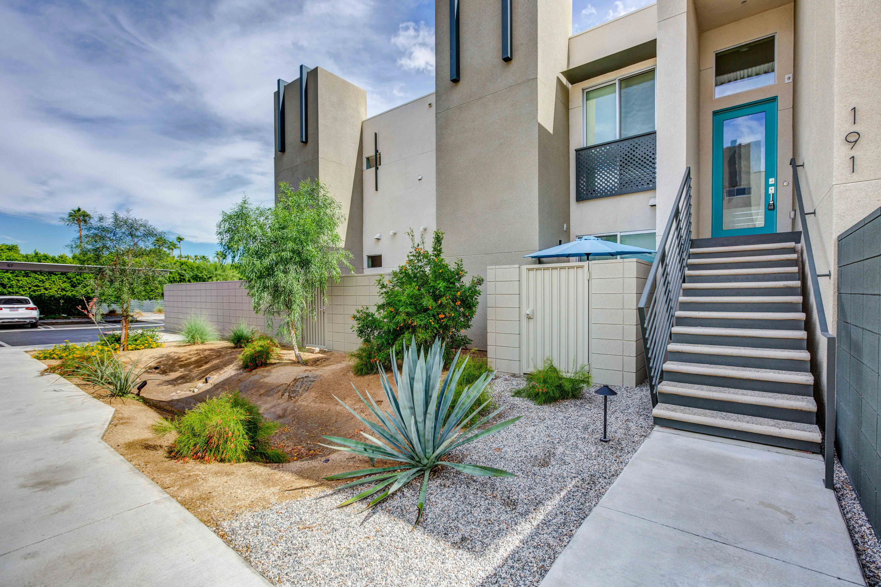 191 The Riv Palm Springs, CA 92262 - Photo 3 of 33 a view of a house with backyard and plants