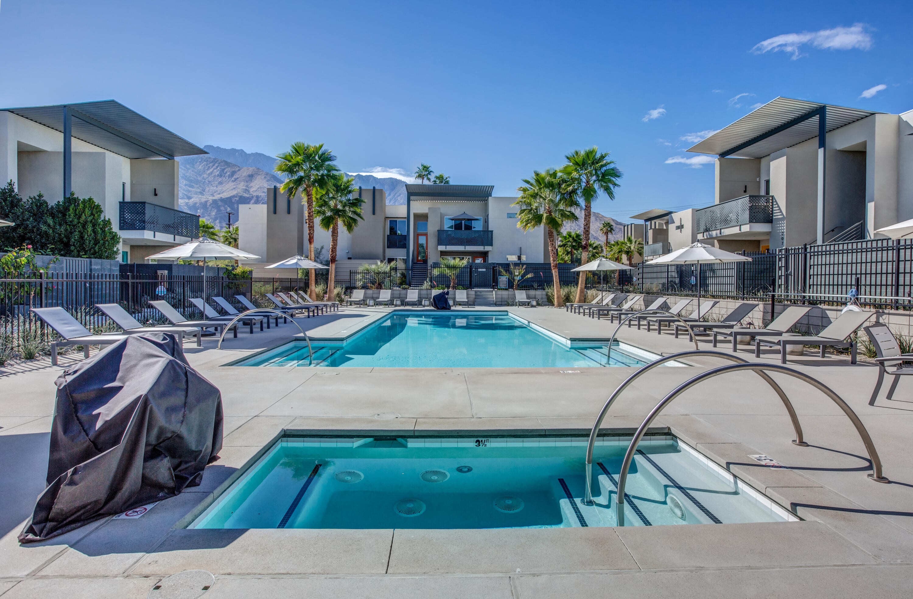 191 The Riv Palm Springs, CA 92262 - Photo 29 of 33 a swimming pool with outdoor seating and yard