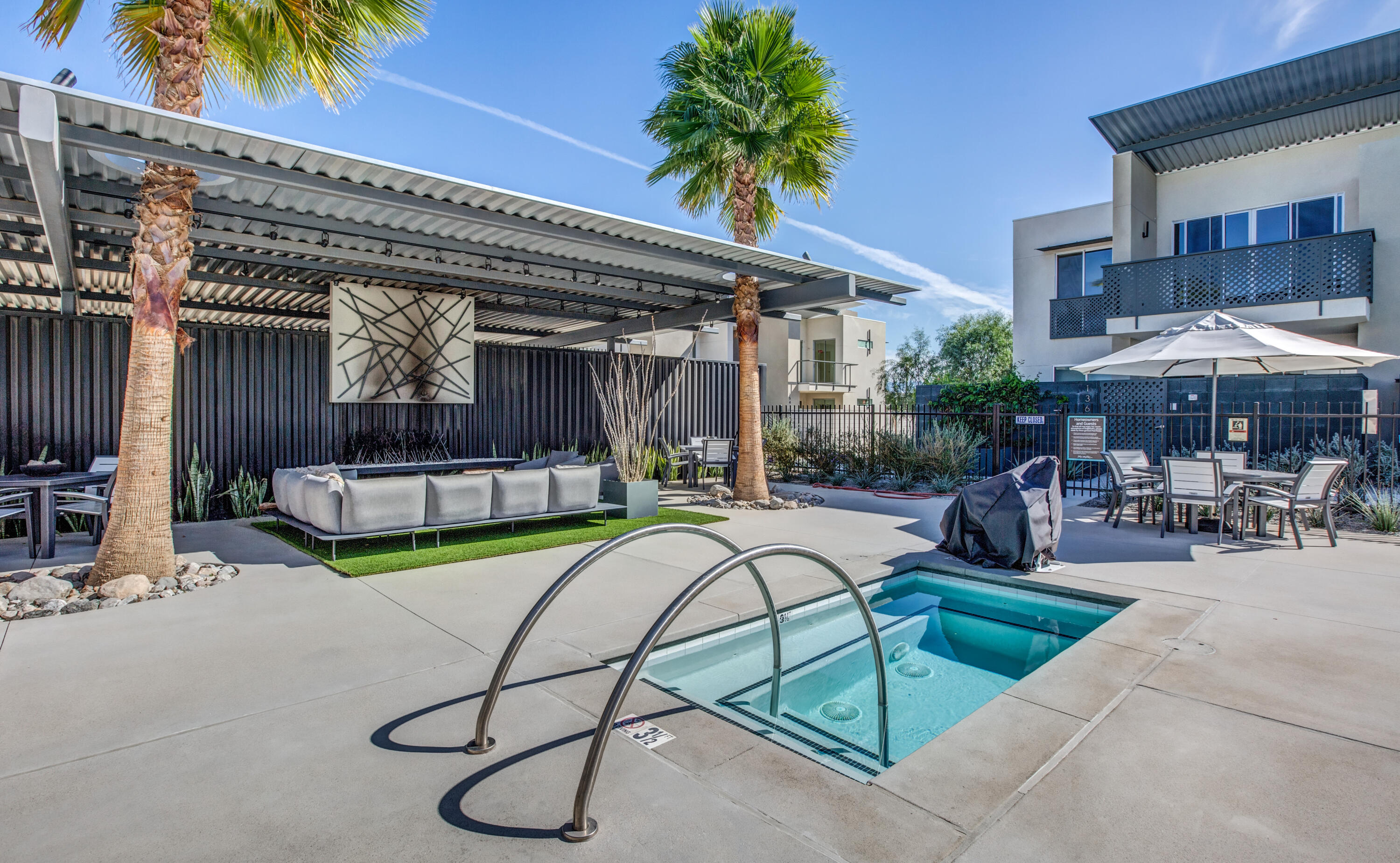 191 The Riv Palm Springs, CA 92262 - Photo 30 of 33 a view of a swimming pool with chairs and tables