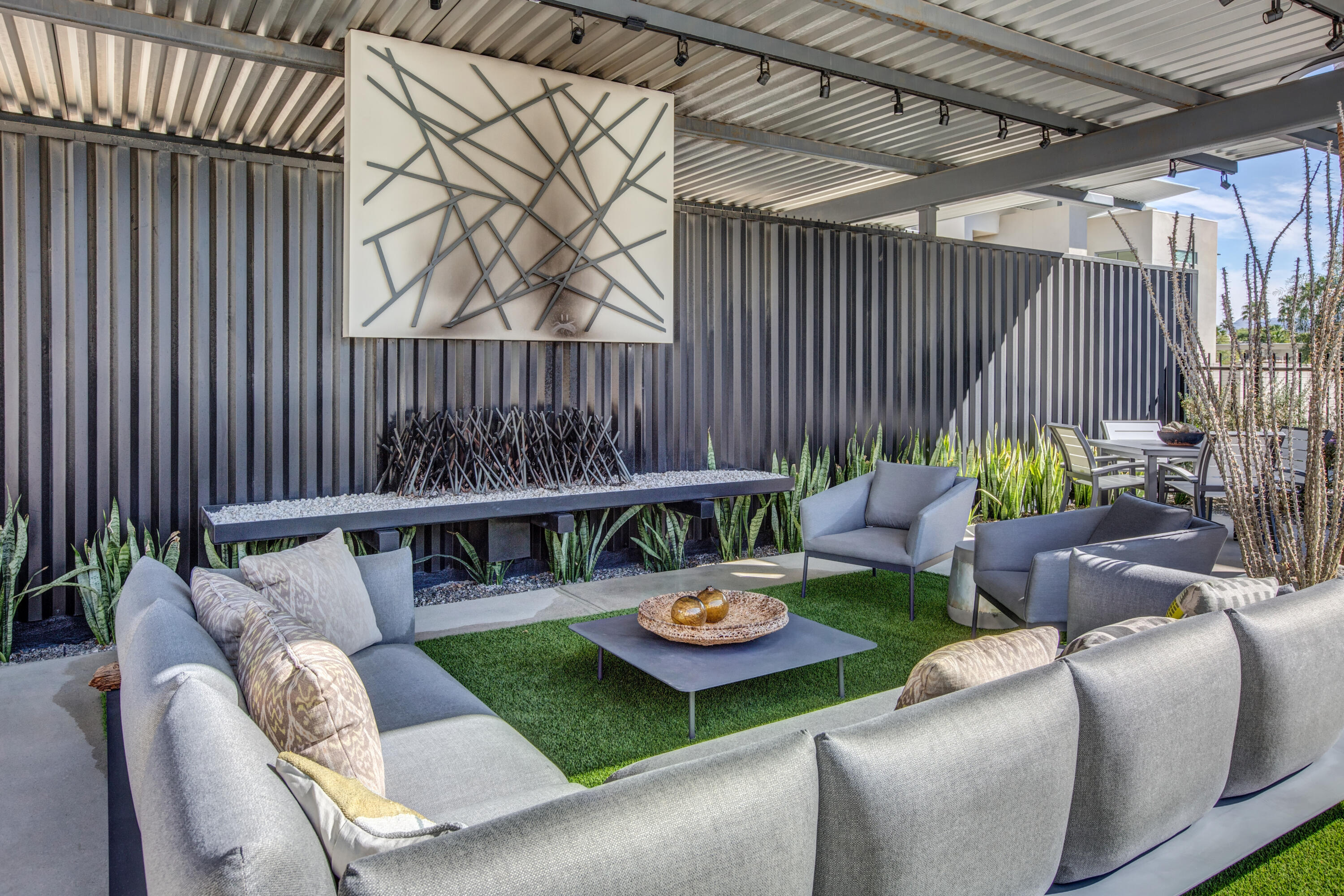 191 The Riv Palm Springs, CA 92262 - Photo 31 of 33 a view of a patio with a dining table and chairs with wooden fence