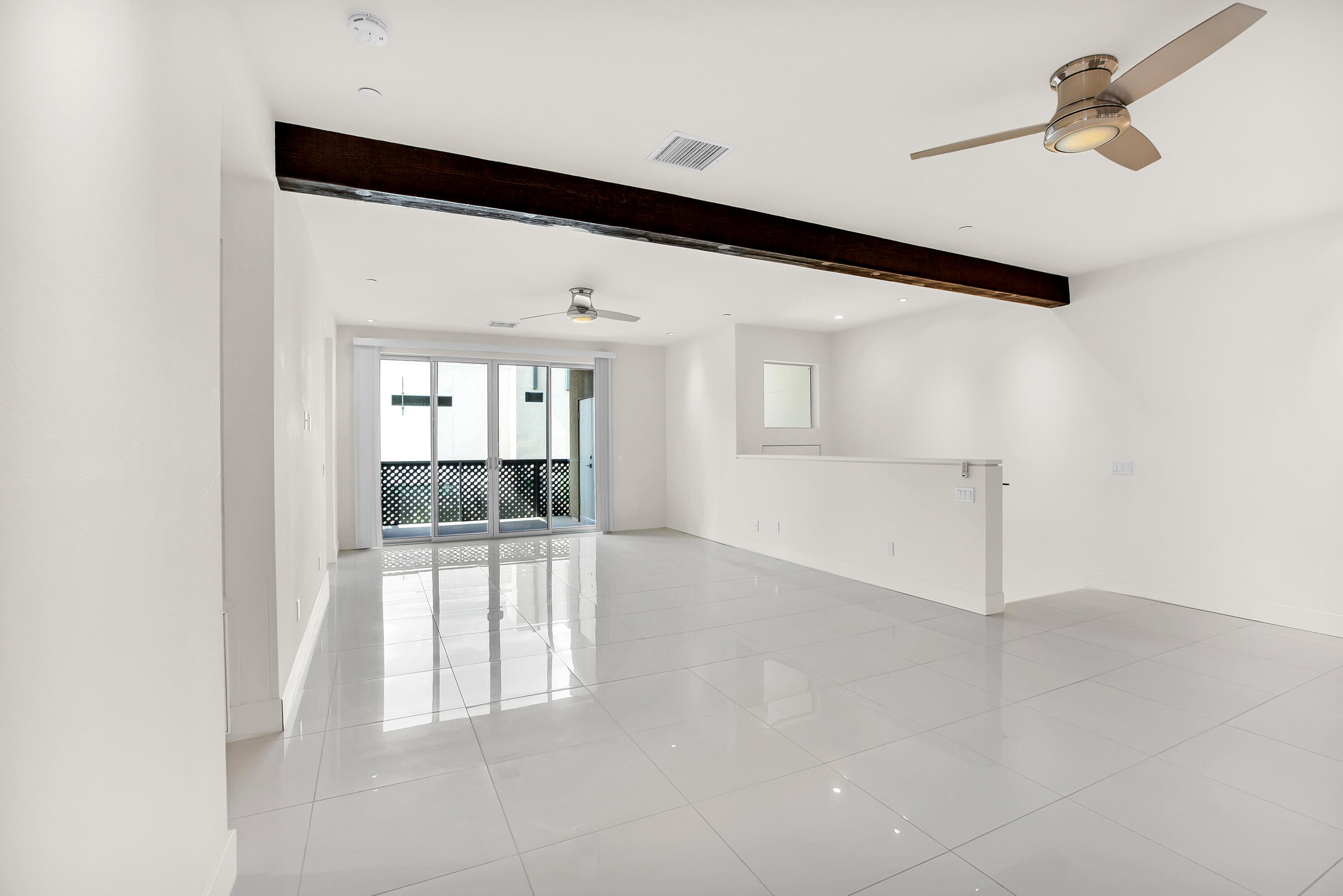 191 The Riv Palm Springs, CA 92262 - Photo 6 of 33 a view of a hallway with wooden floor and a living room