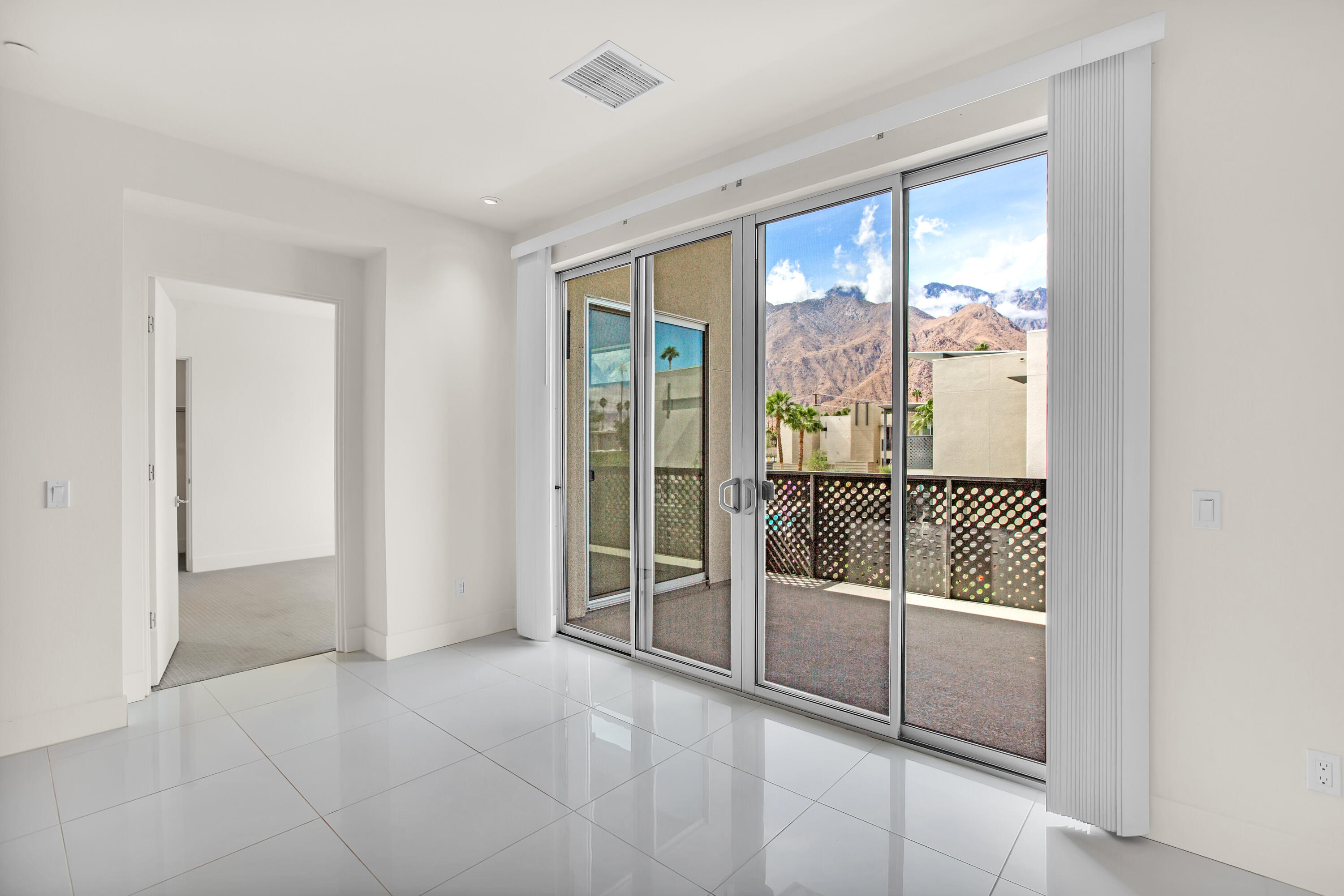 191 The Riv Palm Springs, CA 92262 - Photo 8 of 33 a view of a room with sliding door and wooden floor
