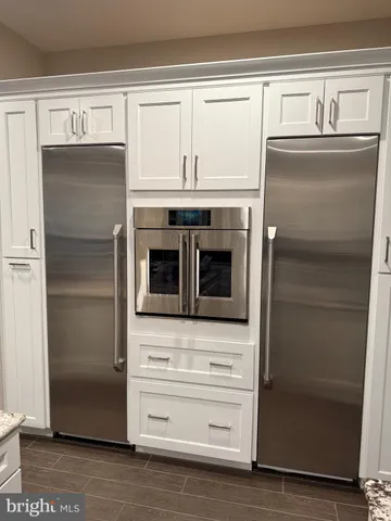 a kitchen with granite countertop cabinets and steel stainless steel appliances