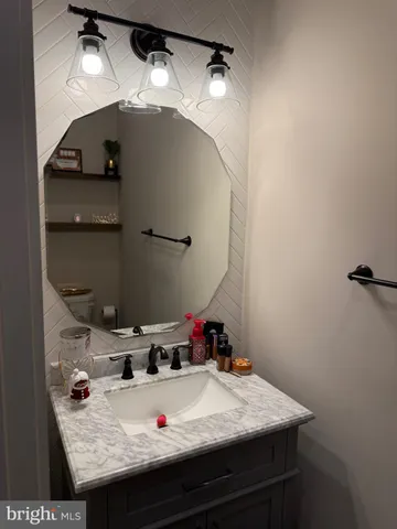 a bath room with a sink and a mirror