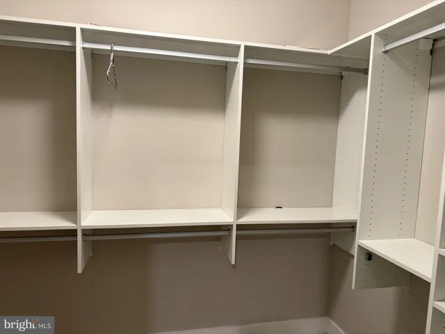 a bed sitting in a bedroom next to a lamp