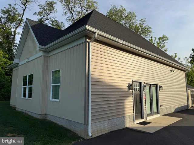 a view of a small house with a yard