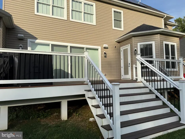 a view of a house with wooden fence