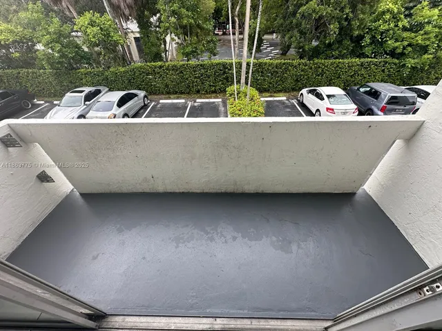 a view of a swimming pool with outdoor seating and plants