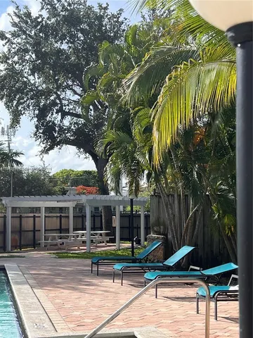 a view of a house with backyard porch and sitting area