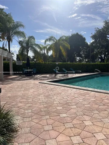 a swimming pool with outdoor seating and yard