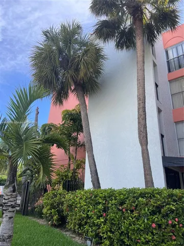 a view of a palm trees in front of a house