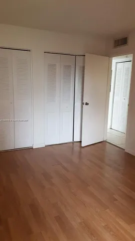 a view of an empty room and wooden floor