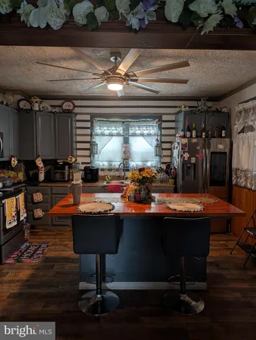 a room with table chairs and wooden floor